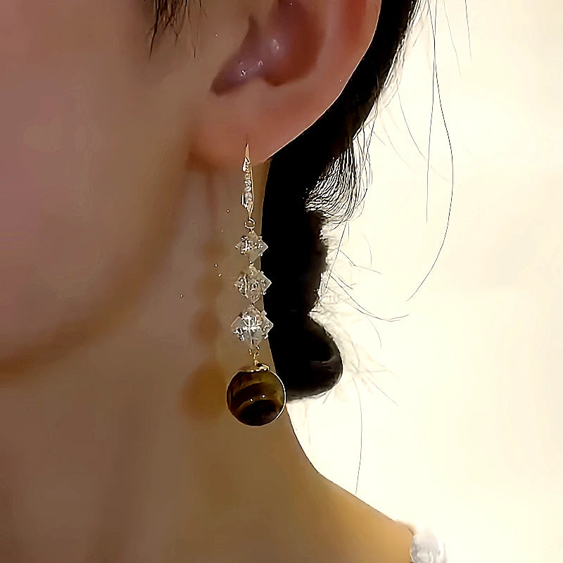 Close-up detail of the sparkling zircons and plating on the Pearl Threader Earrings