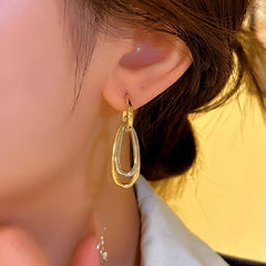 Close-up detail of the sparkling zircons and plating on the Geometric Pendant Earrings