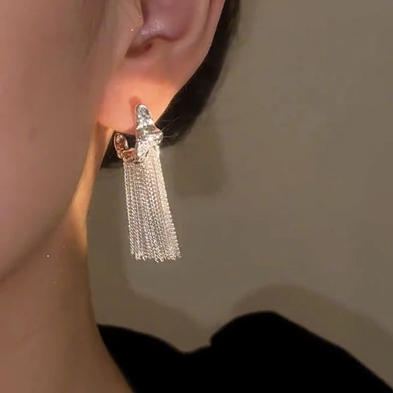 Model showcasing the dangle and style of the 14K Gold-plated Geometric Tassel Earrings