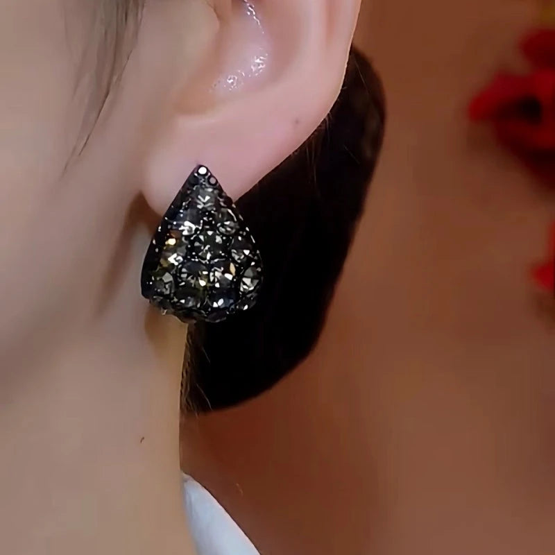 Model showcasing the dangle and style of the 14K Gold-plated Gray Zircon Earrings
