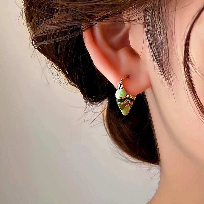 Angled view of the 14K Gold-plated Green Heart Earrings