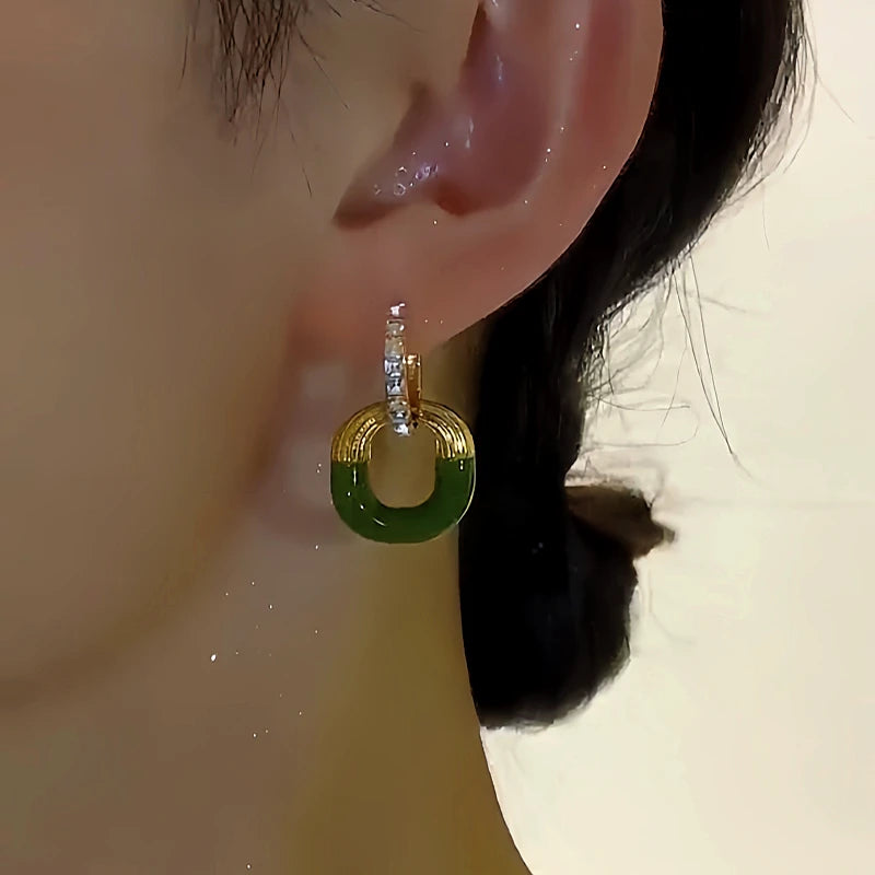 Close-up detail of the sparkling zircons and plating on the Green Square Earrings