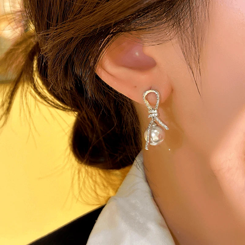 Close-up detail of the sparkling zircons and plating on the Knotted Tassel Earrings