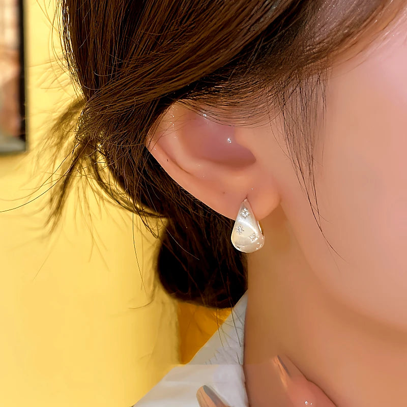 Close-up detail of the sparkling zircons and plating on the Brushed Drop Earrings