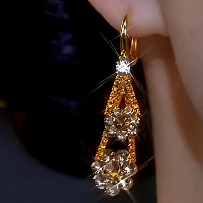 Model showcasing the dangle and style of the 14K Gold-plated Luxury Diamond Flower Earrings