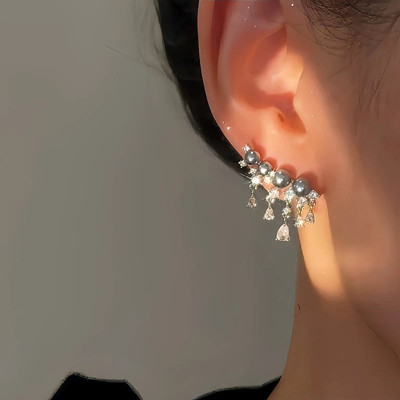 Model showcasing the dangle and style of the 14K Gold-plated Luxury Diamond Gray Pearl Tassel Earrings