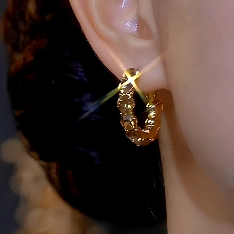 Model showcasing the dangle and style of the 14K Gold-plated Luxury Diamond Hoop Earrings