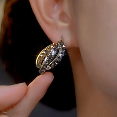 Model showcasing the dangle and style of the 14K Gold-plated Luxury Diamond Hoop Earrings