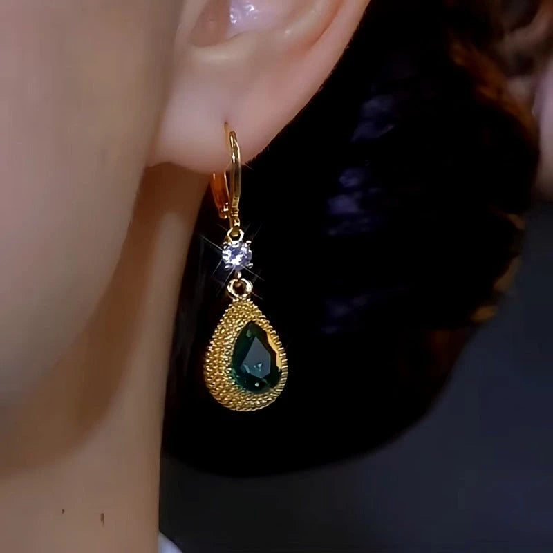 Model showcasing the dangle and style of the 14K Gold-plated Luxury Green Crystal Durian Earrings