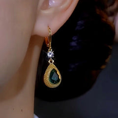 Model showcasing the dangle and style of the 14K Gold-plated Luxury Green Crystal Durian Earrings