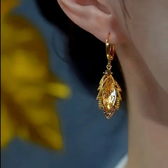 Model showcasing the dangle and style of the 14K Gold-plated Luxury Jade Crystal Earrings