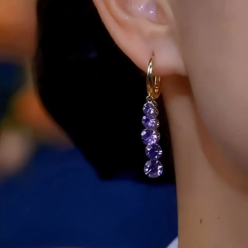 Model showcasing the dangle and style of the 14K Gold-plated Luxury Purple Zircon Diamond Earrings