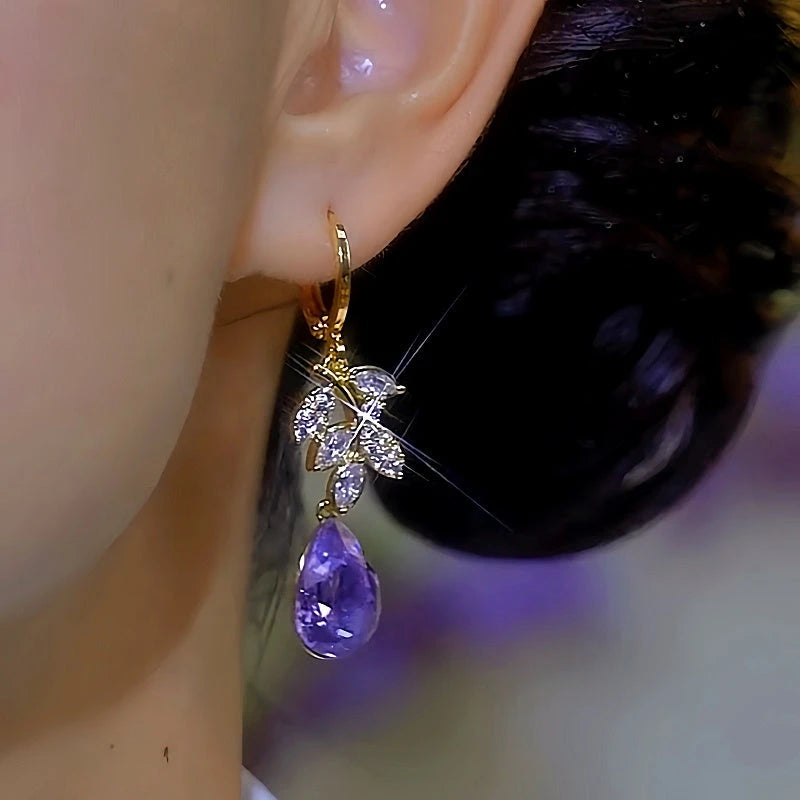 Model showcasing the dangle and style of the 14K Gold-plated Luxury Purple Zircon Water Drop Earrings