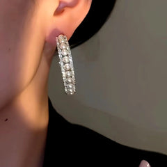 Model showcasing the dangle and style of the 14K Gold-plated Luxury Simple Beads Hoop Earrings