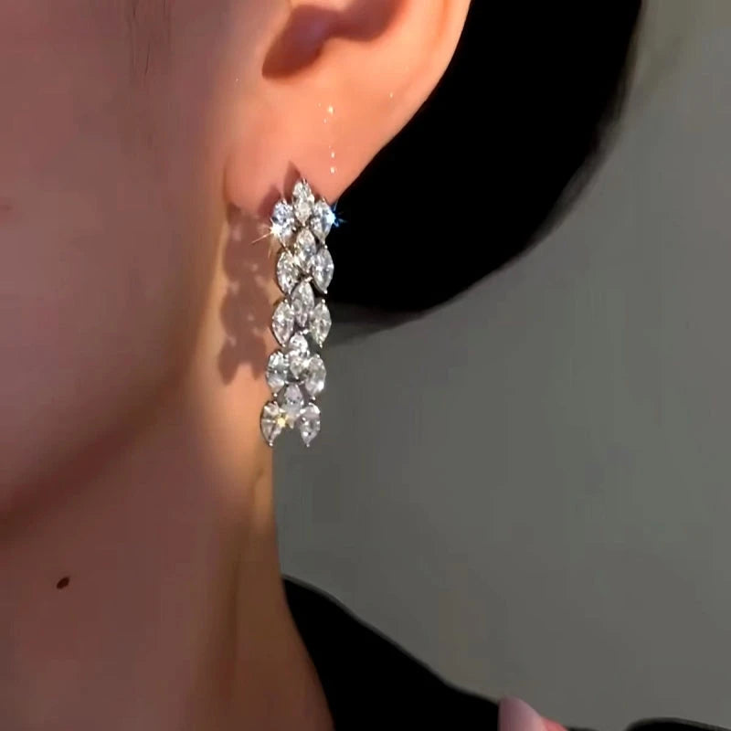 Model showcasing the dangle and style of the 14K Gold-plated Luxury Simple Zircon Tassel Earrings