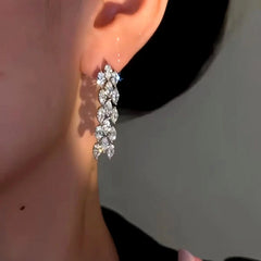 Model showcasing the dangle and style of the 14K Gold-plated Luxury Simple Zircon Tassel Earrings