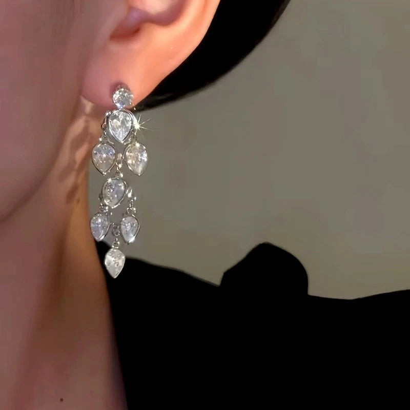 Model showcasing the dangle and style of the 14K Gold-plated Luxury Zircon Tassel Earrings