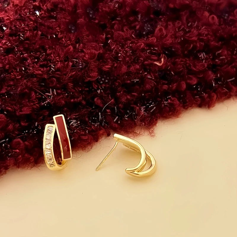 Close-up detail of the sparkling zircons and plating on the Red and Gold Earrings