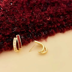 Close-up detail of the sparkling zircons and plating on the Red and Gold Earrings