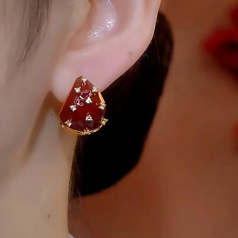 Model showcasing the dangle and style of the 14K Gold-plated Red Strawberry Earrings