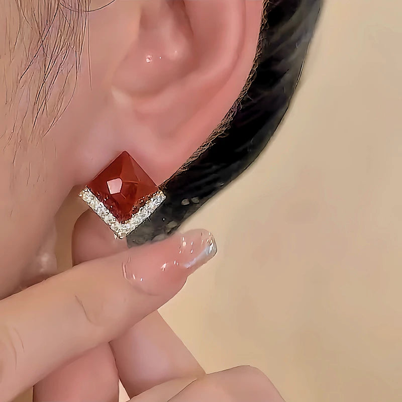 Model showcasing the dangle and style of the 14K Gold-plated Red Zircon Geometric Earrings
