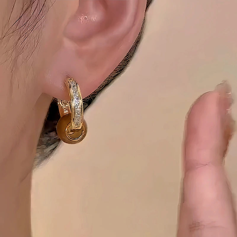 Model showcasing the dangle and style of the 14K Gold-plated Red Zircon Hoop Earrings