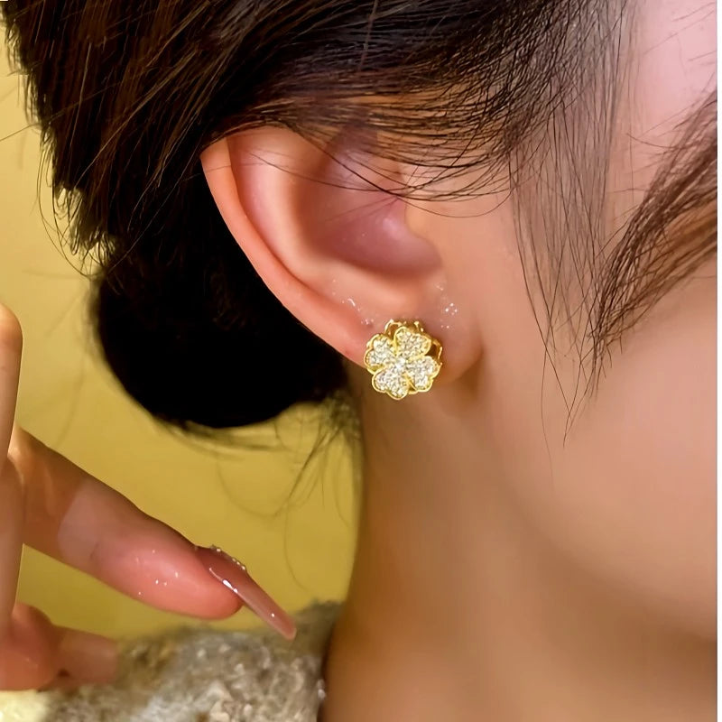 Model showcasing the dangle and style of the 14K Gold-plated Rotating Lucky Clover Earrings