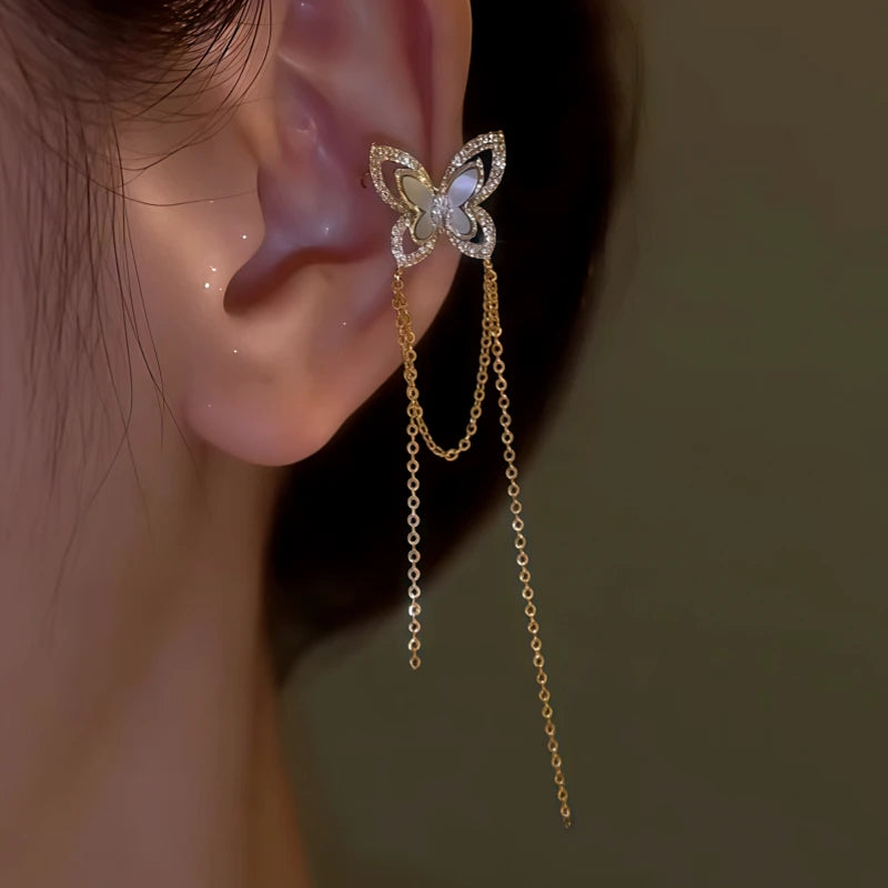 Model showcasing the dangle and style of the 14K Gold-plated Shell Butterfly Tassel Ear Cuffs (1 Pair)