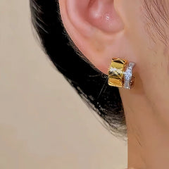 Model showcasing the dangle and style of the 14K Gold-plated Silver-Gold Stud Earrings