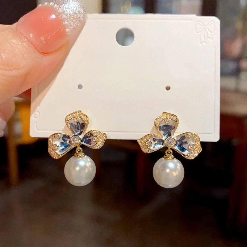 Angled view of the 14K Gold-plated Simple Flower Pearl Earrings