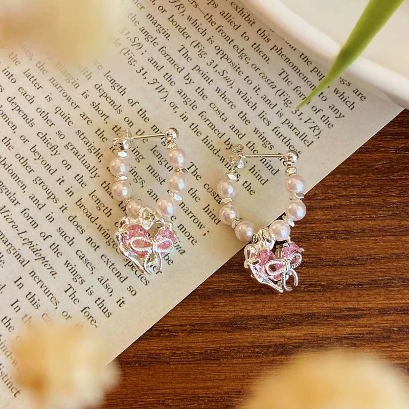 Close-up detail of the sparkling zircons and plating on the Bow Heart Earrings