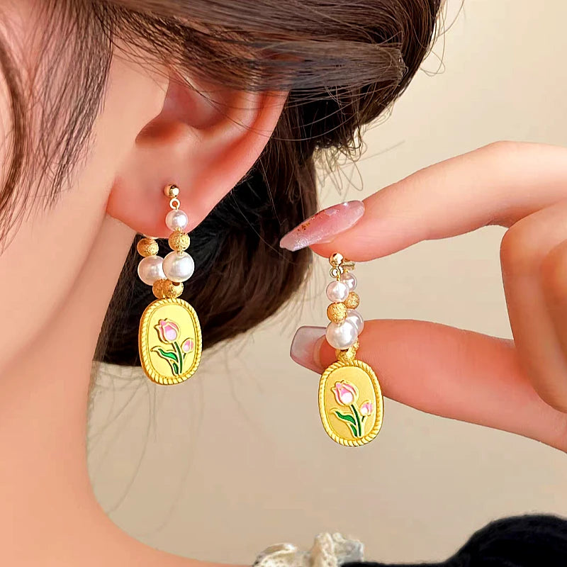 Angled view of the 14K Gold-plated Tulip Pearl Earrings