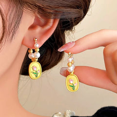 Angled view of the 14K Gold-plated Tulip Pearl Earrings