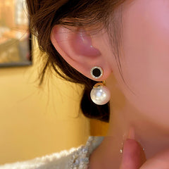 Model showcasing the dangle and style of the 14K Gold-plated Two-Piece Bead Earrings