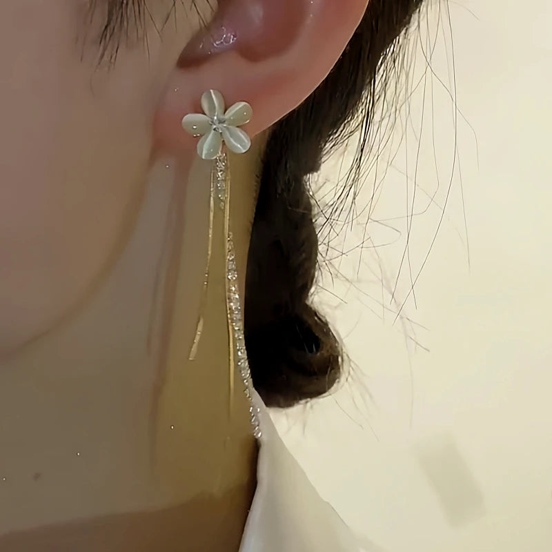 Model showcasing the dangle and style of the 14K Gold-plated Two-Piece Flower Earrings