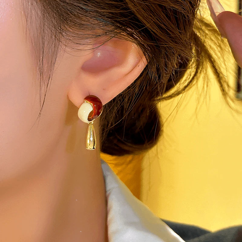 Model showcasing the dangle and style of the 14K Gold-plated Water Drop Tassel Earrings