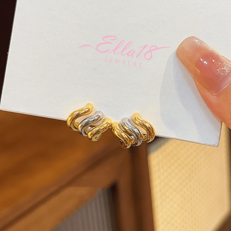 Angled view of the 14K Gold-plated Wavy Three-Layer Stud Earrings