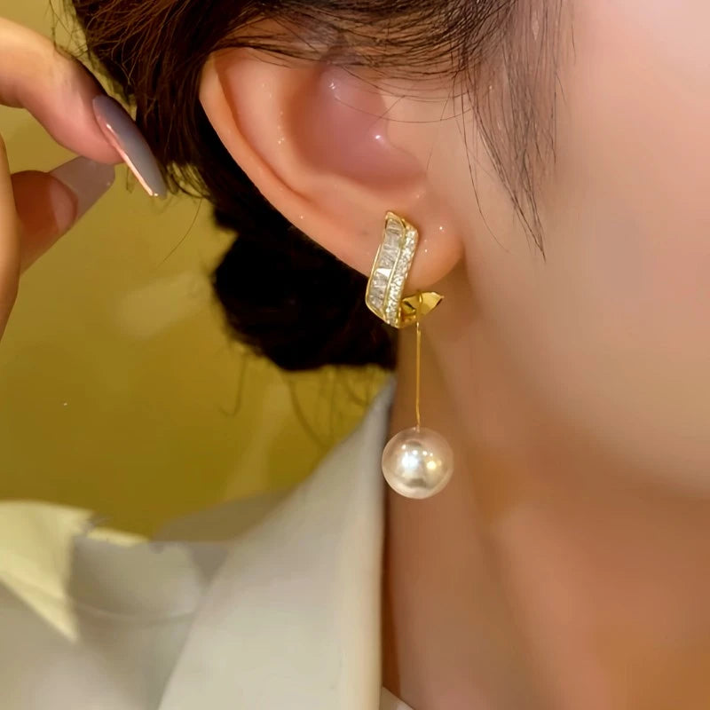 Model showcasing the dangle and style of the 14K Gold-plated Zircon Bead Tassel Earrings