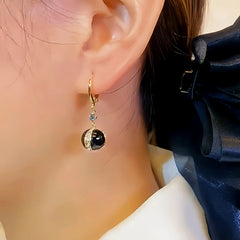 Model showcasing the dangle and style of the 14K Gold-plated Zircon Black Pearl Earrings