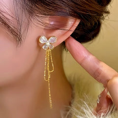 Model showcasing the dangle and style of the 14K Gold-plated Zircon Butterfly Tassel Earrings