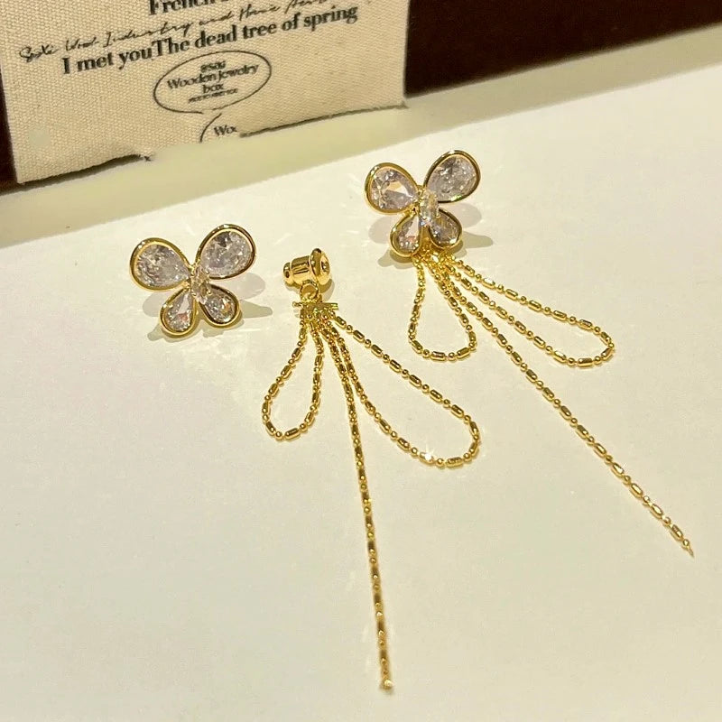 Angled view of the 14K Gold-plated Zircon Butterfly Tassel Earrings