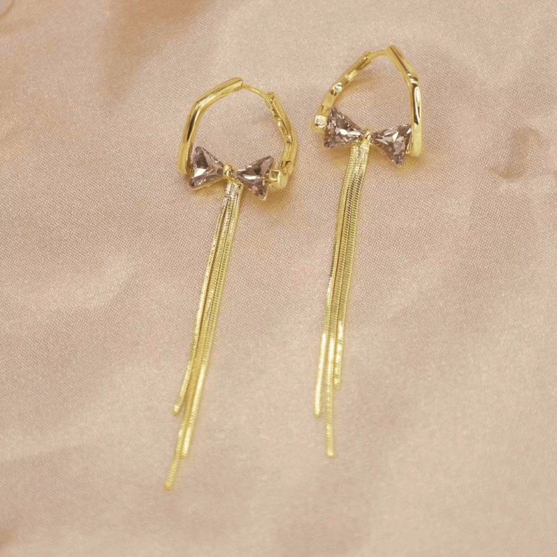 Close-up detail of the sparkling zircons and plating on the Diamond Bow Tassel Earrings