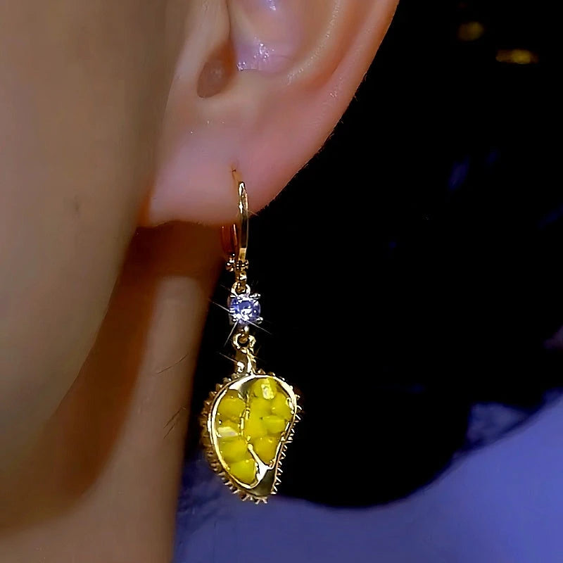 Model showcasing the dangle and style of the 14K Gold-plated Zircon Durian Earrings