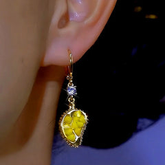 Model showcasing the dangle and style of the 14K Gold-plated Zircon Durian Earrings