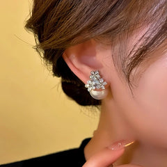 Close-up detail of the sparkling zircons and plating on the Silver Flower Ear Jackets
