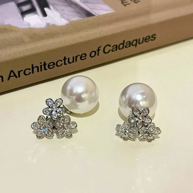 Angled view of the 14K Gold-plated Zircon Flower Jacket Earrings