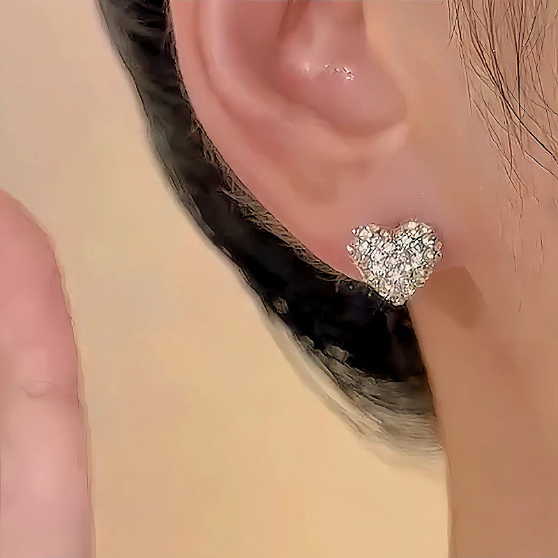 Model showcasing the dangle and style of the 14K Gold-plated Zircon Heart Pearl Earrings