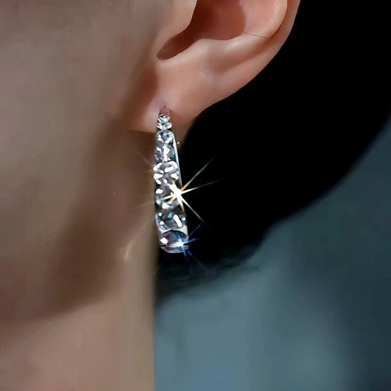 Model showcasing the dangle and style of the 14K Gold-plated Zircon Hoop Earrings