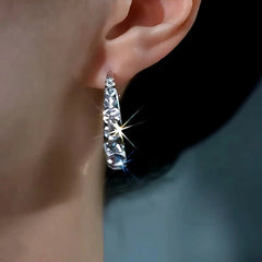 Model showcasing the dangle and style of the 14K Gold-plated Zircon Hoop Earrings