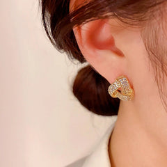 Model showcasing the dangle and style of the 14K Gold-plated Zircon Triangle Stud Earrings